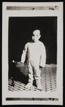 Unidentified toddler standing on checkered flooring, copy 2 of 2