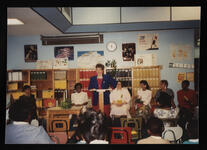 Unidentified individual speaking to unidentified group at a North Tulsa Black Professional Women's Club installation at Carver Middle School in Tulsa, Oklahoma