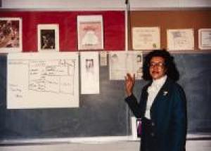 Eddie Faye Gates in front of chalkboard, March 3, 1989
